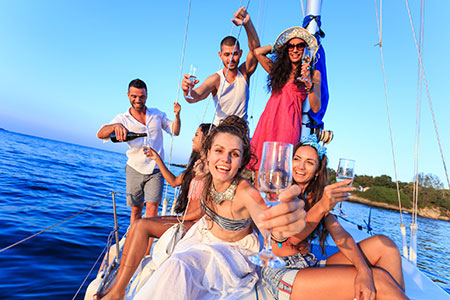 Luxury catamaran Valkyrie sailing past mansions in Sag Harbor labor day weekend