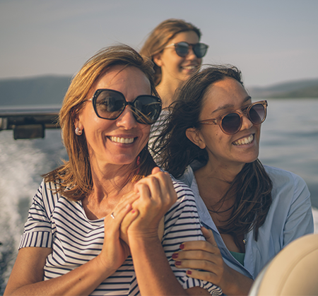 Friends relaxing on sun deck during private Hamptons yacht charter