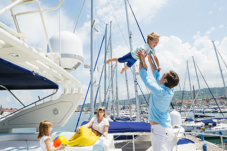 Parents and children smiling during a private kids sailing charter with Valkyrie Sailing in the Hamptons.